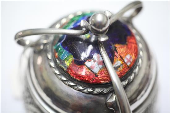 An Edwardian Arts & Crafts planished silver and enamel circular box and cover by Ramsden and Carr, height 11.5cm.